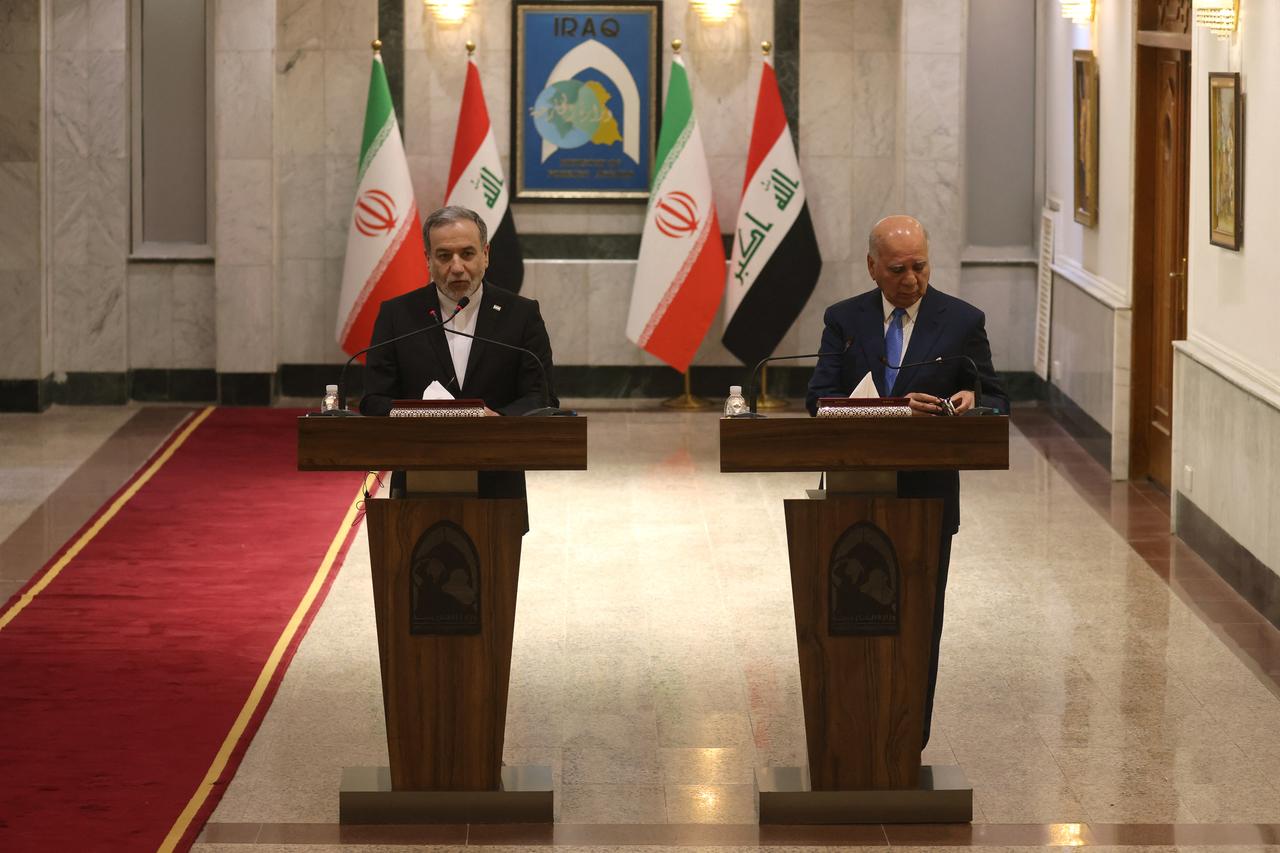 Iranian Foreign Minister Abbas Araghchi (L) and Iraqi Foreign Minister Fuad Hussein hold a joint press conference following a meeting in Baghdad on June 28, 2026. (AFP Photo)