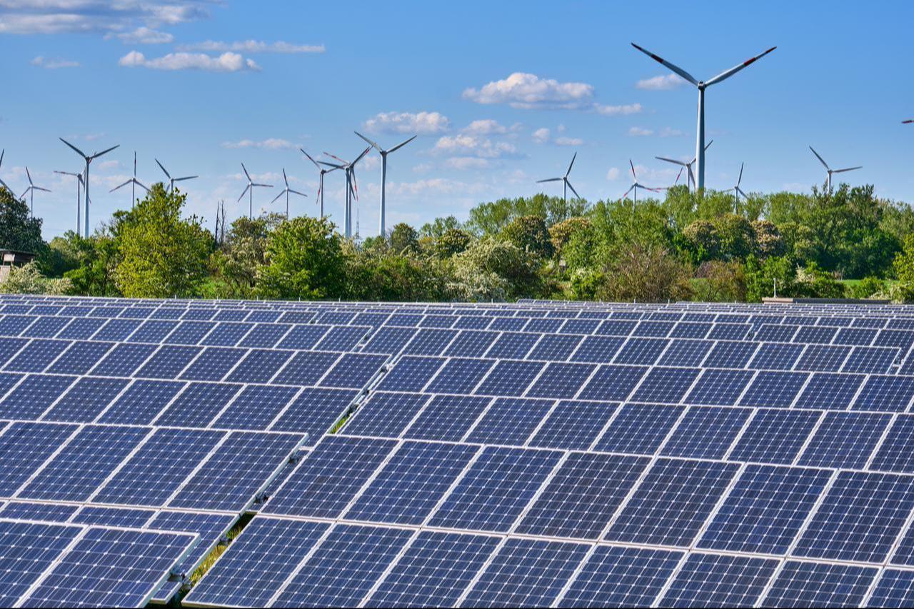 Solar panels and wind turbines are seen at a renewable energy site in Germany. (Adobe Stock Photo)
