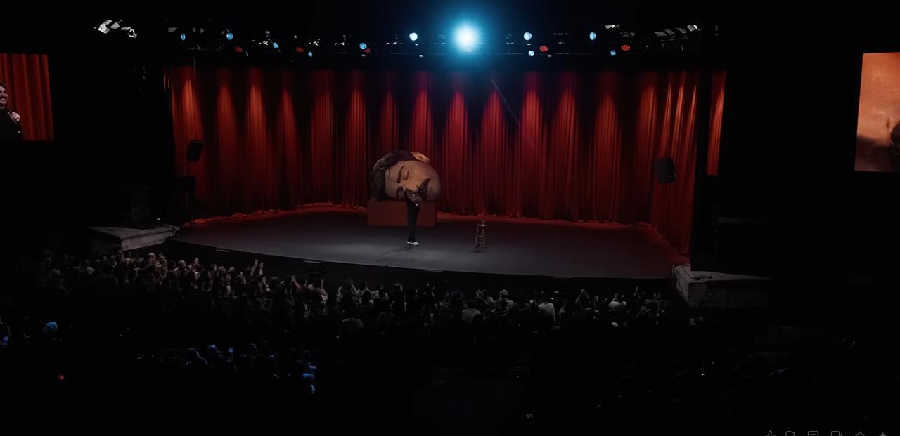 Deniz Göktaş performs during his stand-up show “Dead Deniz” in a 2026 YouTube screenshot. (Photo via YouTube)