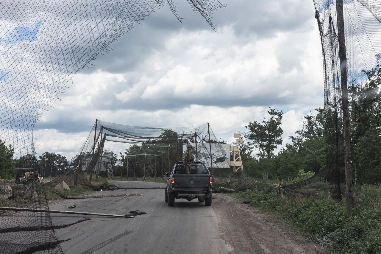 A Ukrainian soldier keeps an eye out for drones from the back of a pick-up truck on a road in the city of Druzhkivka, Ukraine, 28 June 2026. (AA Photo)