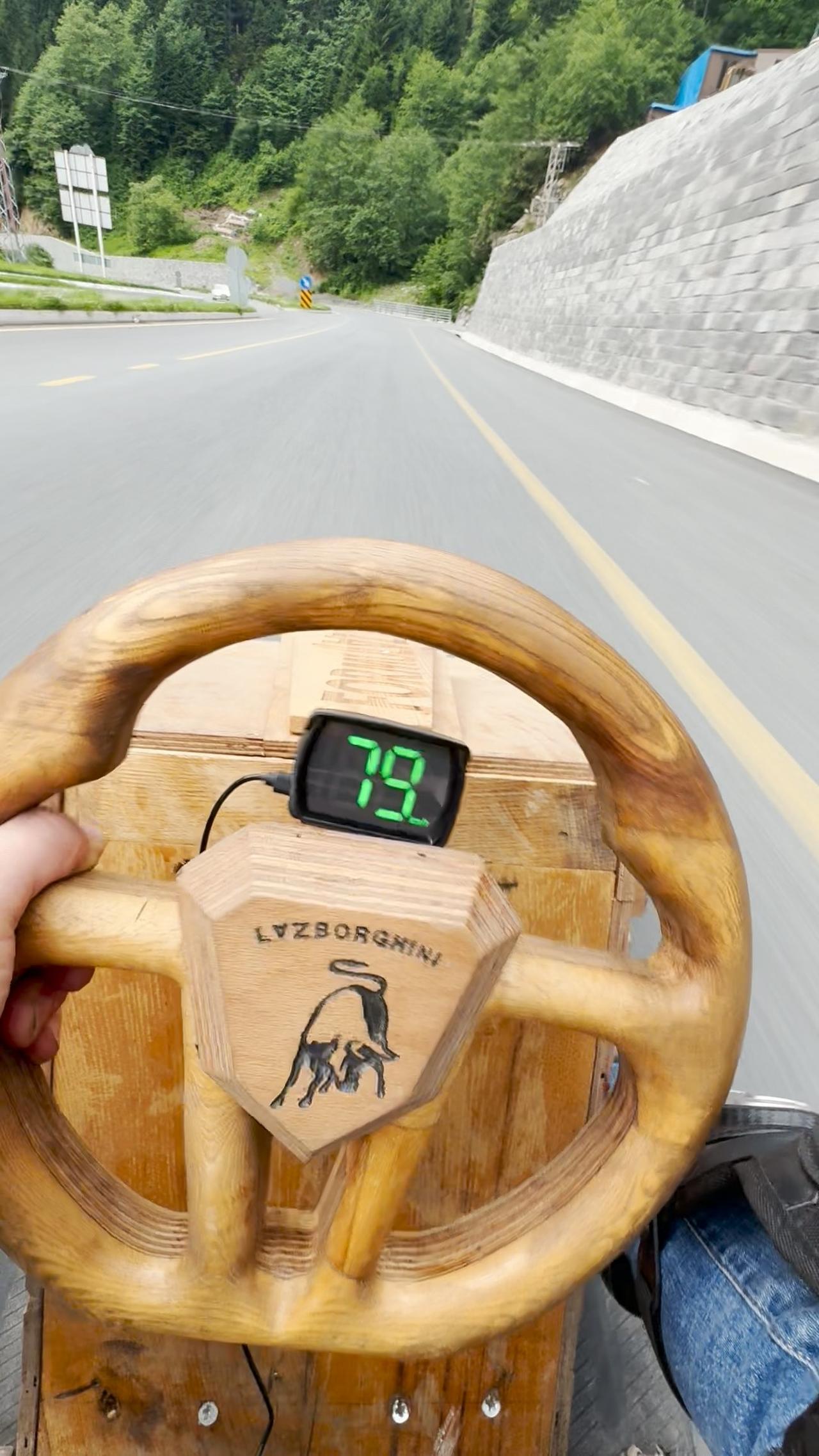 A speed display shows 79 km/h as the wooden vehicle nicknamed “Lazborghini” is driven on a road in Rize, Türkiye. (IHA Photo)