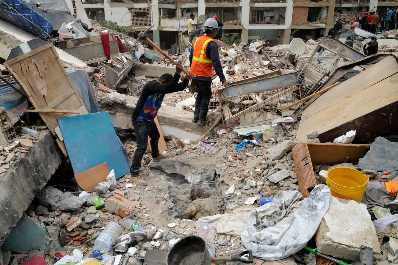 A rescuer breaks up the rubble with a pickaxe while trying to retrieve a body in Caraballeda, La Guaira State, Venezuela on June 28, 2026, following twin earthquakes. (AFP Photo)