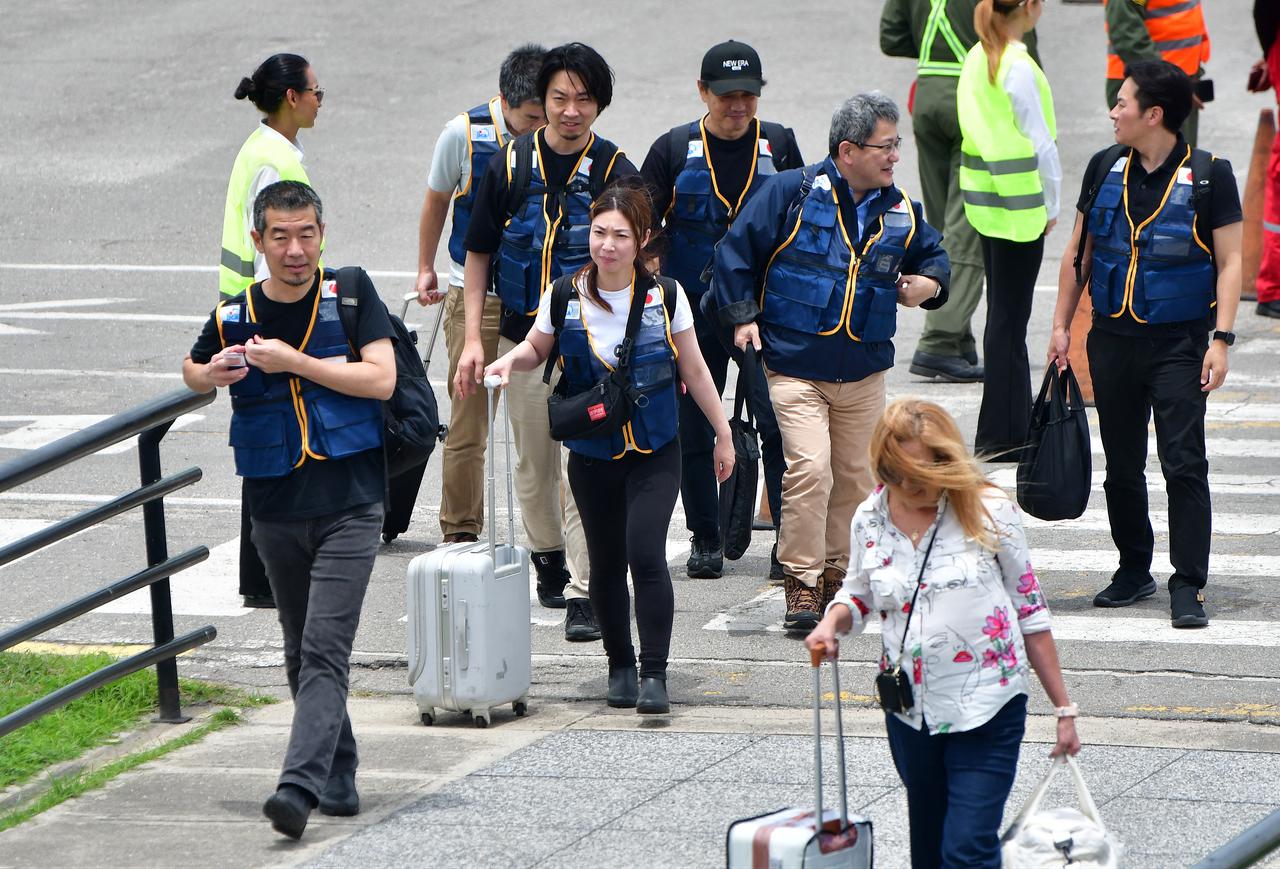 Rescuers of the Japan International Cooperation Agency walk on arrival at the Arturo Michelena international airport in Valencia, Carabobo state, Venezuela, to help in search operations following twin earthquakes, on June 28, 2026. (AFP Photo)