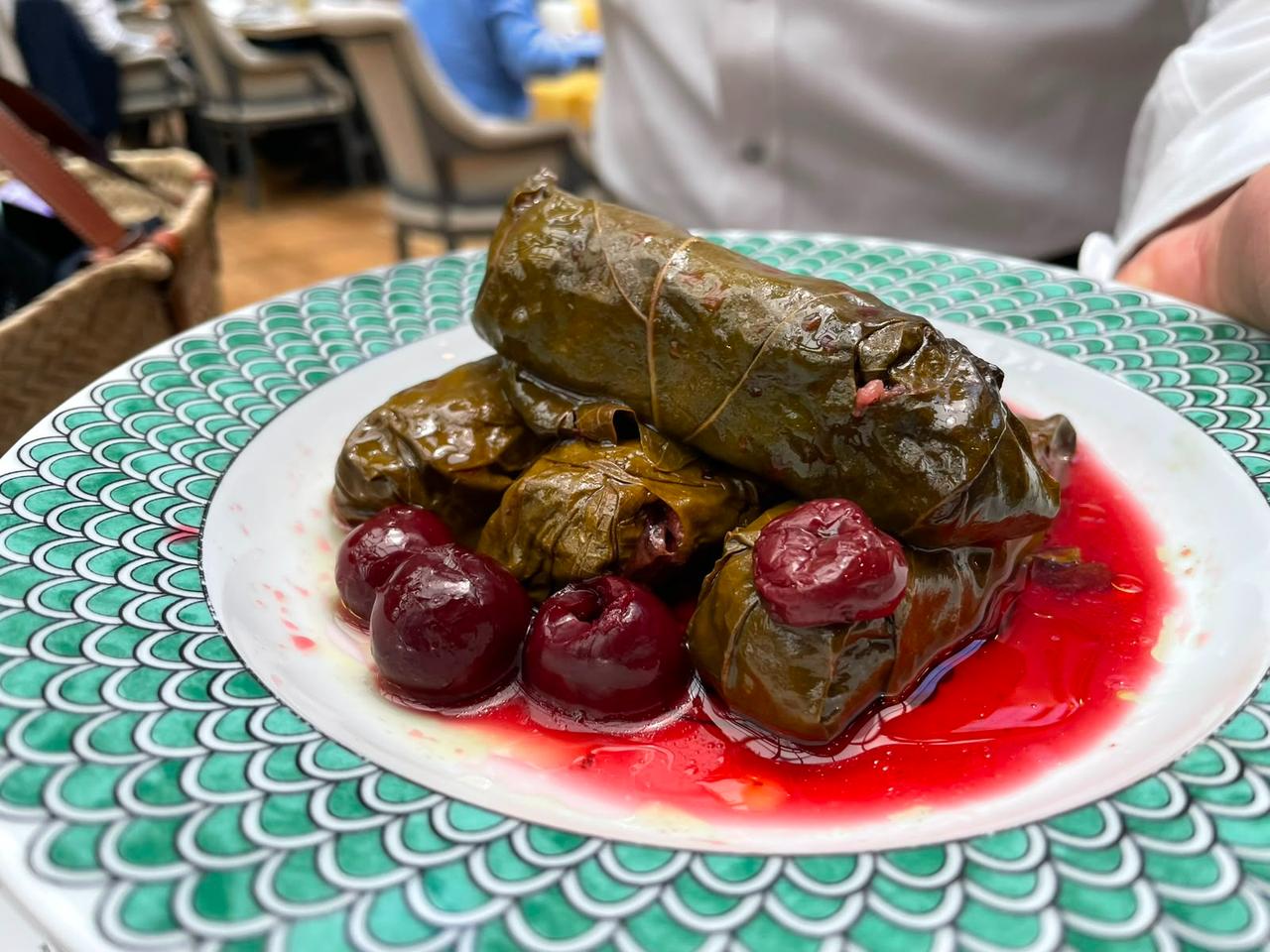 Visneli yaprak sarma, stuffed vine leaves served with sour cherries, is plated during the Bursa tasting in Bursa, Türkiye. (Photo by Koray Erdogan/Türkiye Today)