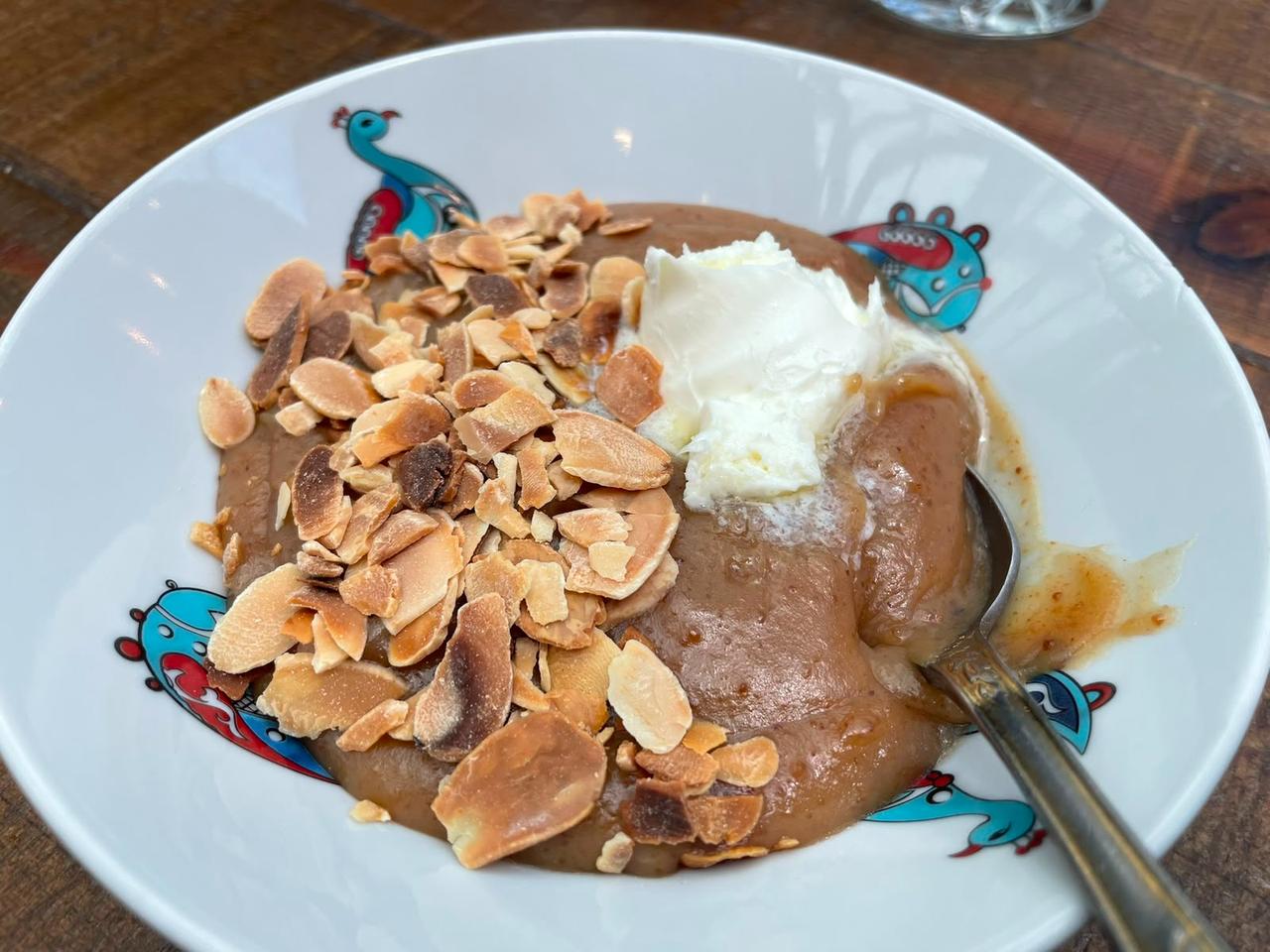 A traditional dessert topped with toasted almond flakes and cream is served at Zennup 1844 in Bursa, Türkiye. (Photo by Koray Erdogan/Türkiye Today)
