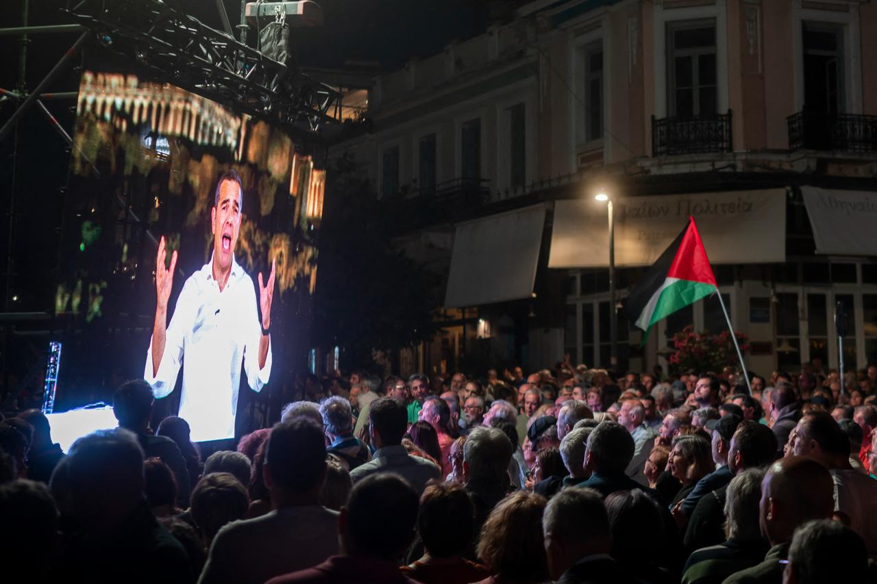 A party supporter holds a Palestinian flag as Greece’s former Prime Minister Alexis Tsipras speaks during the presentation of his new political party ELAS (Hellenic Left Alignment), in Athens on May 26, 2026. (AFP Photo)
