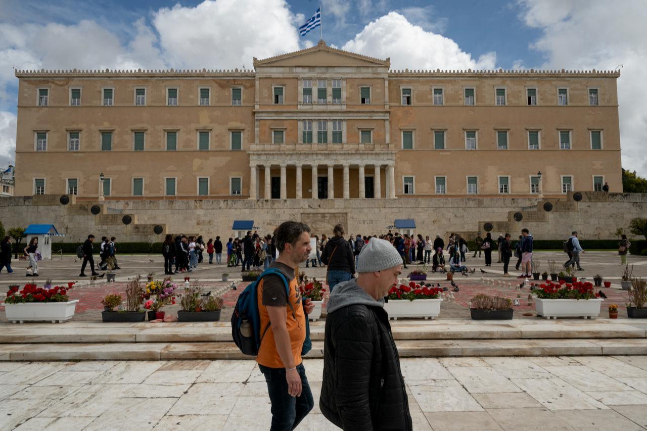 Pedestrians walk past the Greek Parliament building on April 3, 2026. (AFP Photo)