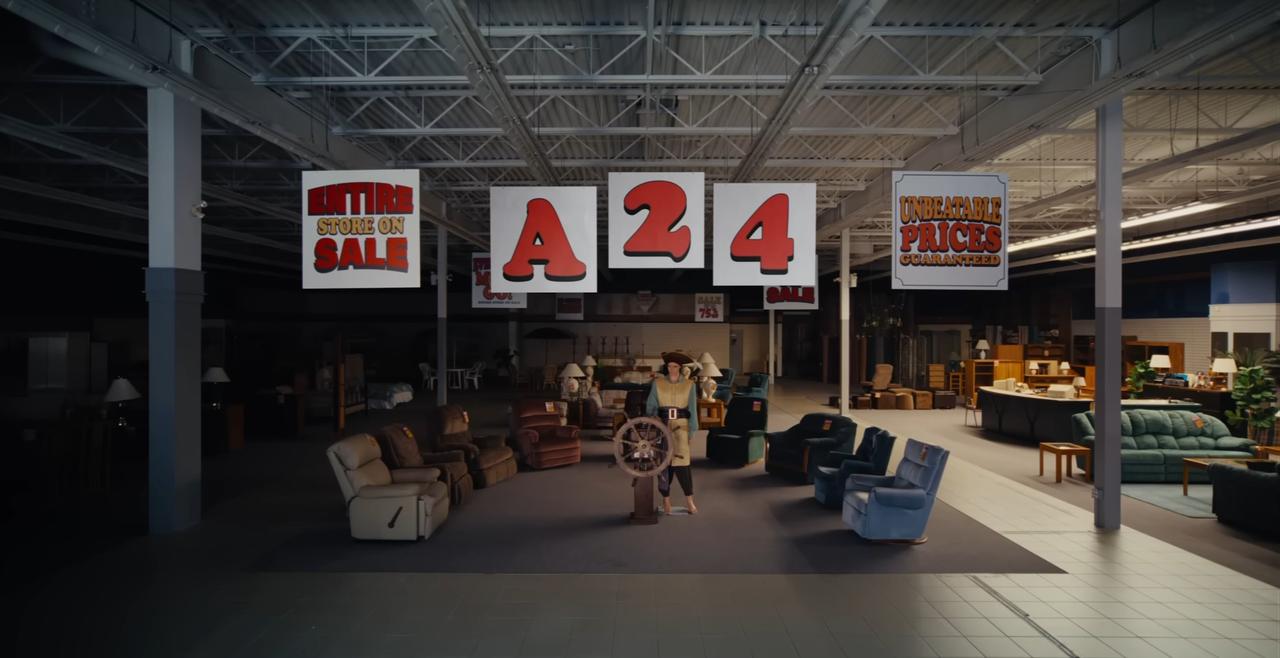 A character stands inside a dimly lit furniture store in a screenshot from the “Backrooms” movie trailer. (Photo via YouTube)