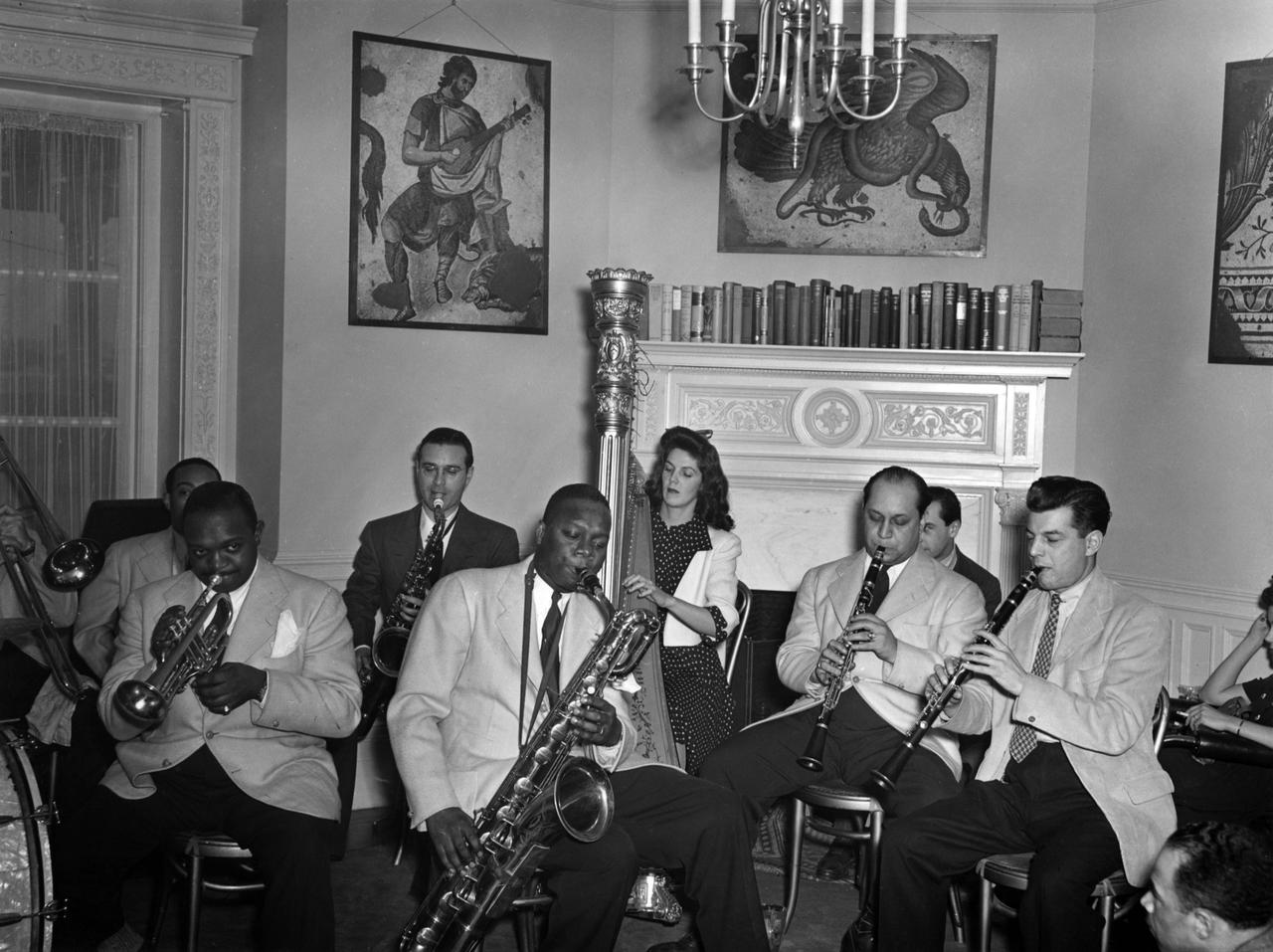 Rex Stewart (trumpet), Harry Carney (baritone), Adele Girard (harp), Barney Bigard (clarinet), Joe Marsala (clarinet) at the Turkish Embassy in Washington, U.S., Jan. 1, 1940. (Photo of Nesuhi Ertegun)