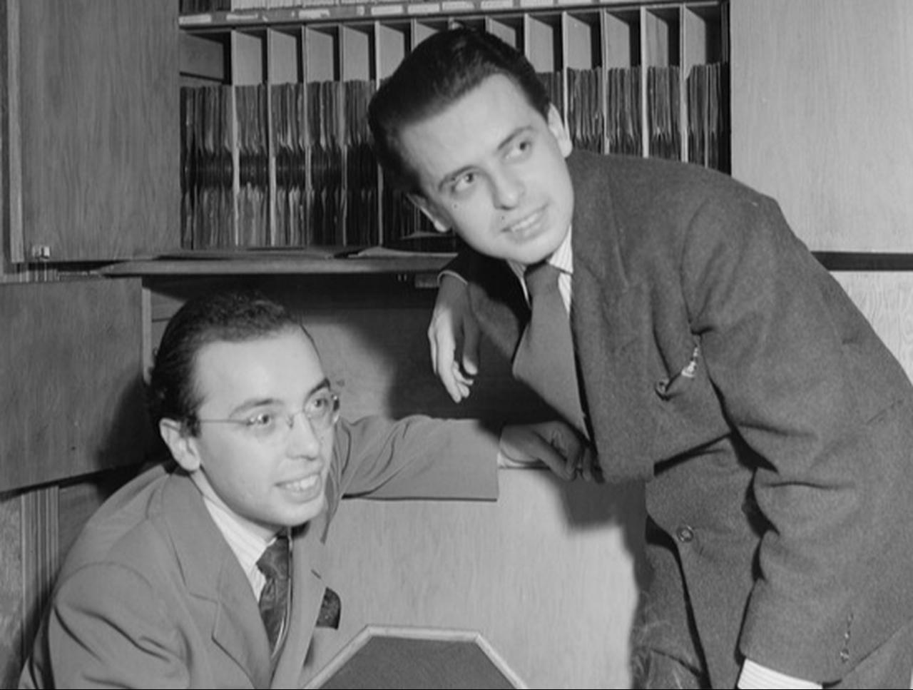 Ahmet M. Ertegun and Nesuhi Ertegun pose in the record room of the Turkish Embassy in Washington, D.C., in the 1930s. (Photo via Library of Congress)