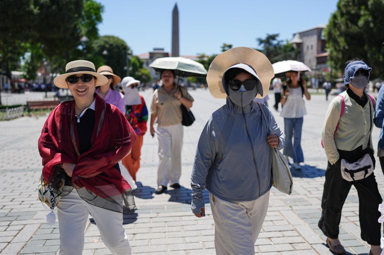 Tourists walk through Sultanahmet Square during hot summer weather in Istanbul, Türkiye, June 28, 2026. (AA Photo)