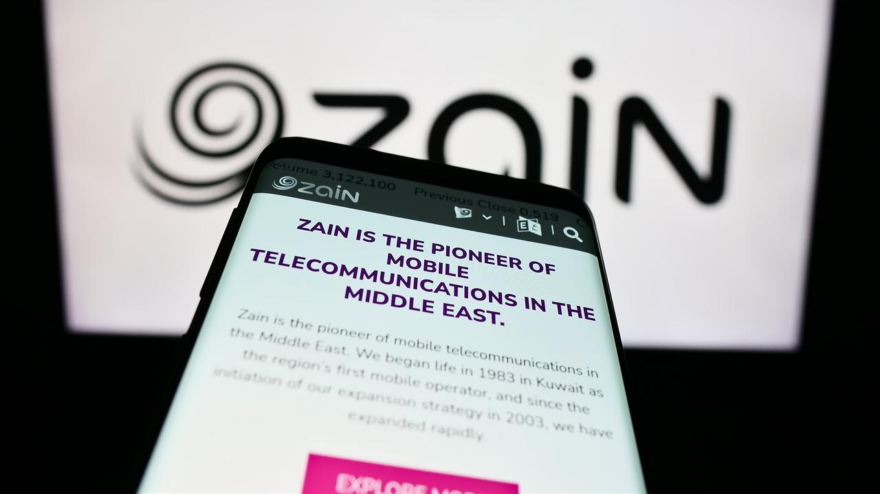 The Zain website is displayed on a mobile phone in front of the company's logo in Stuttgart, Germany, on Aug. 5, 2023. (Adobe Stock Photo)