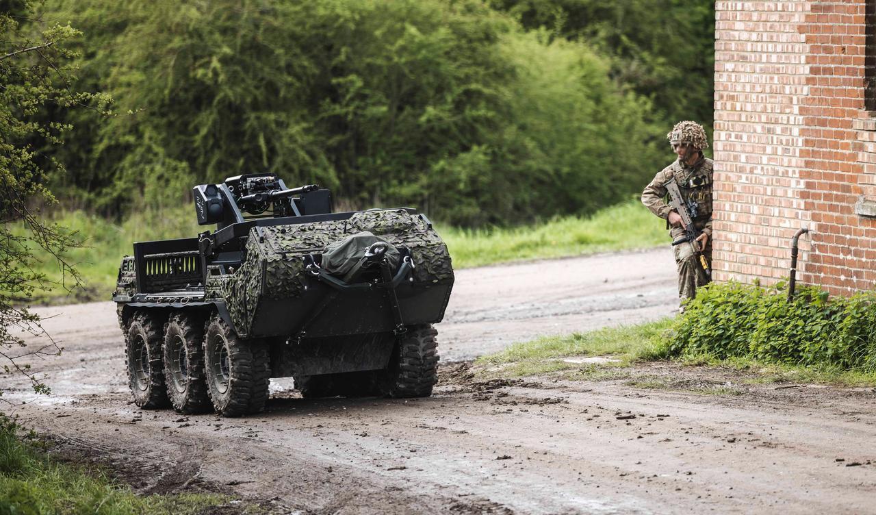 The UK Army's an unmanned vehicle mounted with a .50-caliber machine gun that is being used to cover troops' movements. (DOW © copyright 2026)