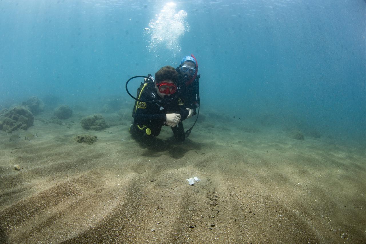 Middle school students who successfully completed an environmental training program and participated in localized waste-collection efforts receive a scuba diving experience as their end-of-term report card reward in the Karaburun district of Izmir, Türkiye, June 21, 2026. (AA Photo)