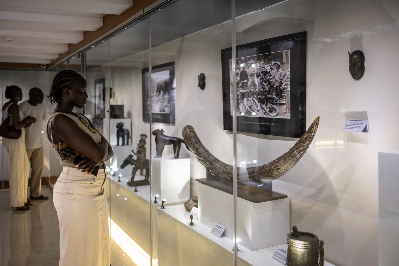 Visitor looks at an elephant tusk from Benin Kingdom inside the National Museum in Lagos on April 23, 2026. (AFP Photo)