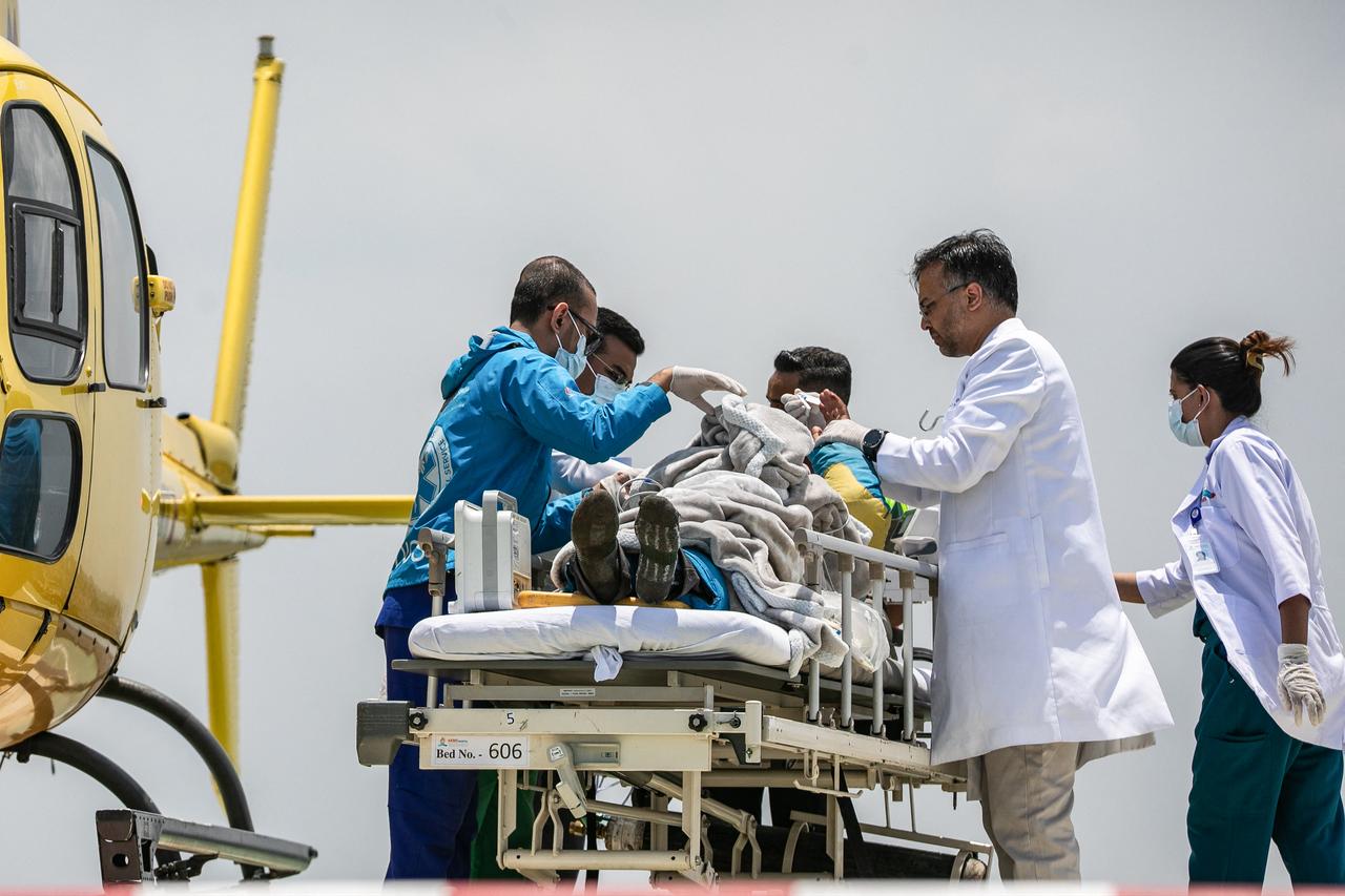 Medics and rescuers transfer mountaineer Dawa Sherpa from a helicopter upon his arrival at the HAMS Hospital in Kathmandu on June 4, 2026. (AFP Photo)
