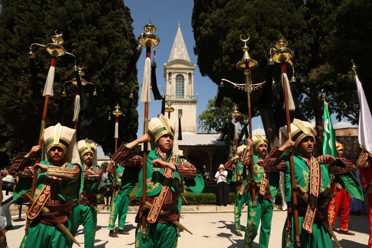 Members of the mehter band carry ceremonial standards during a traditional Ottoman military music performance at Topkapi Palace in Istanbul, Türkiye. (AA Photo)