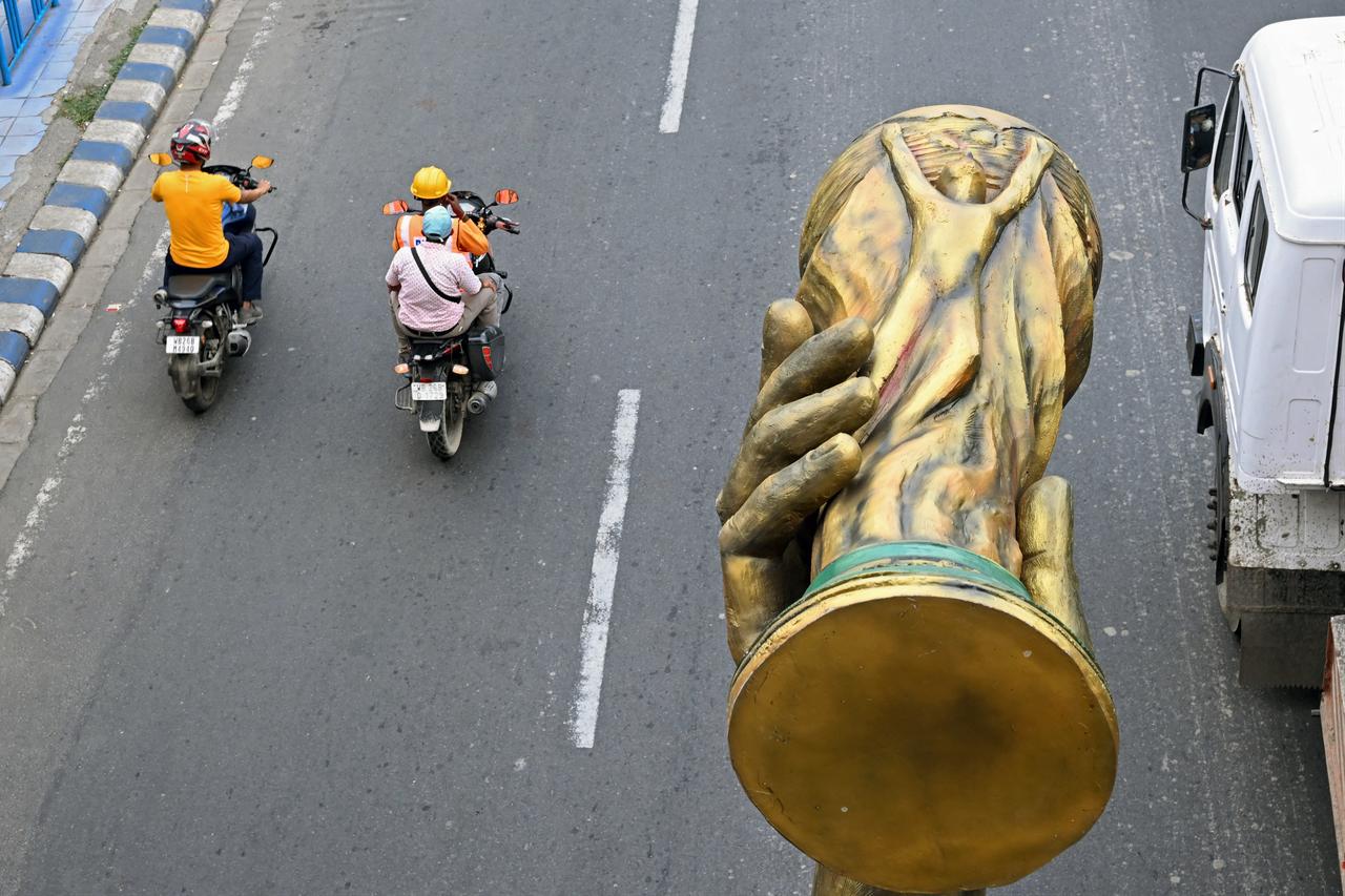 Workers transport a statue of Argentine football player Lionel Messi featuring a replica of the FIFA World Cup trophy, after its removal for re-installation to a safer place in Kolkata, June 1, 2026. (AFP Photo)