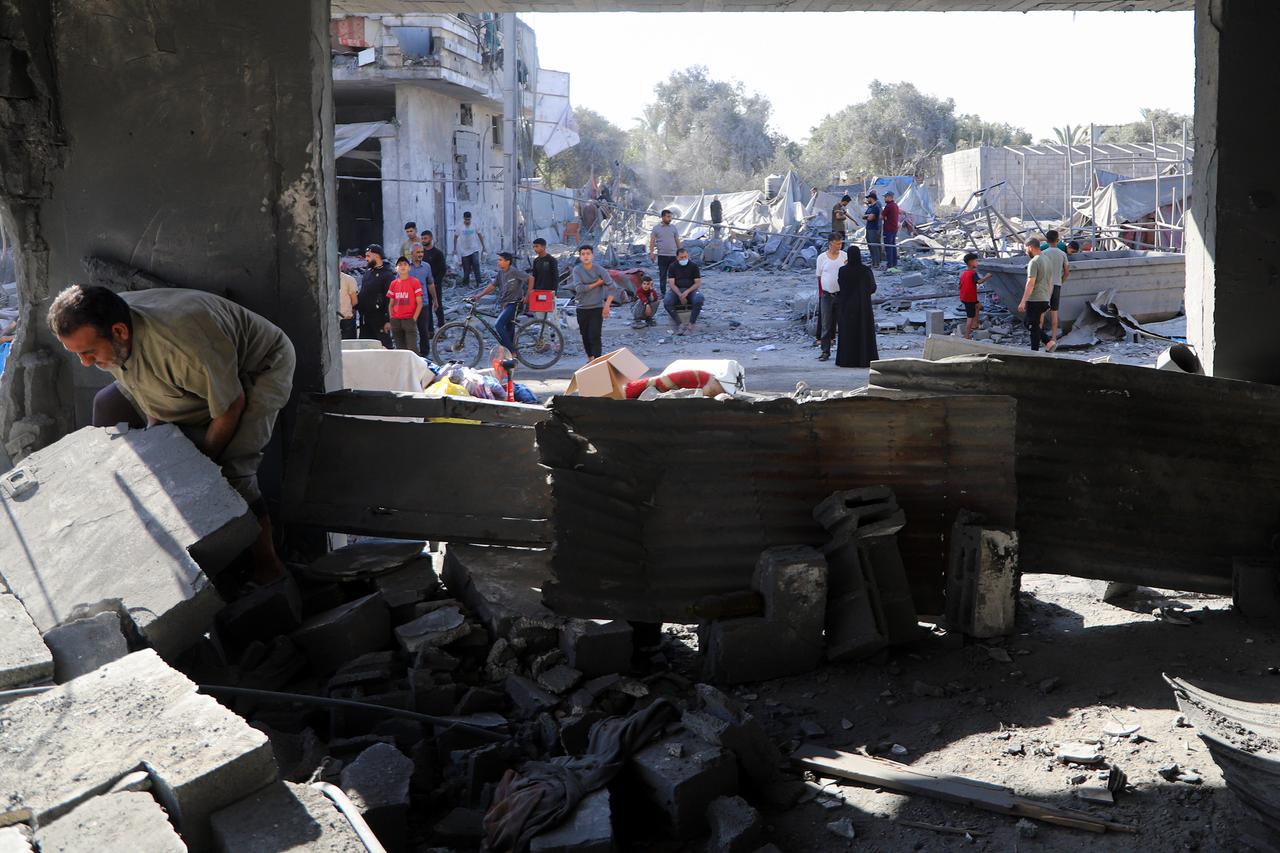 Palestinians retrieve some of their belongings that remained intact under the rubble after the Israeli army violated the ceasefire by targeting a building, which is owned by the Darwish family in the Nuseirat Camp, in Deir al-Balah, Gaza, Palestine on June 05, 2026. (AA Photo)