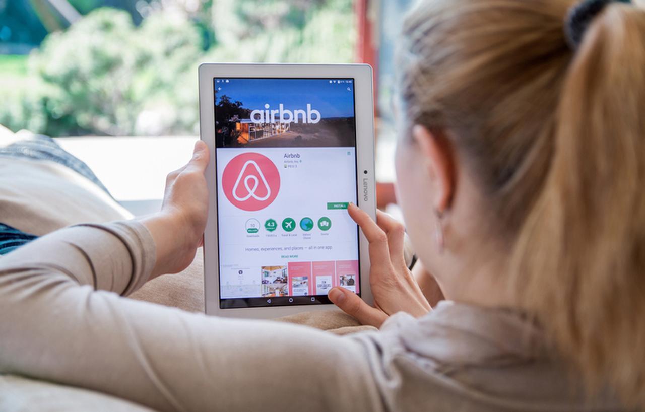 A woman browses the San Francisco-based Airbnb application (Bloomberg Photo)