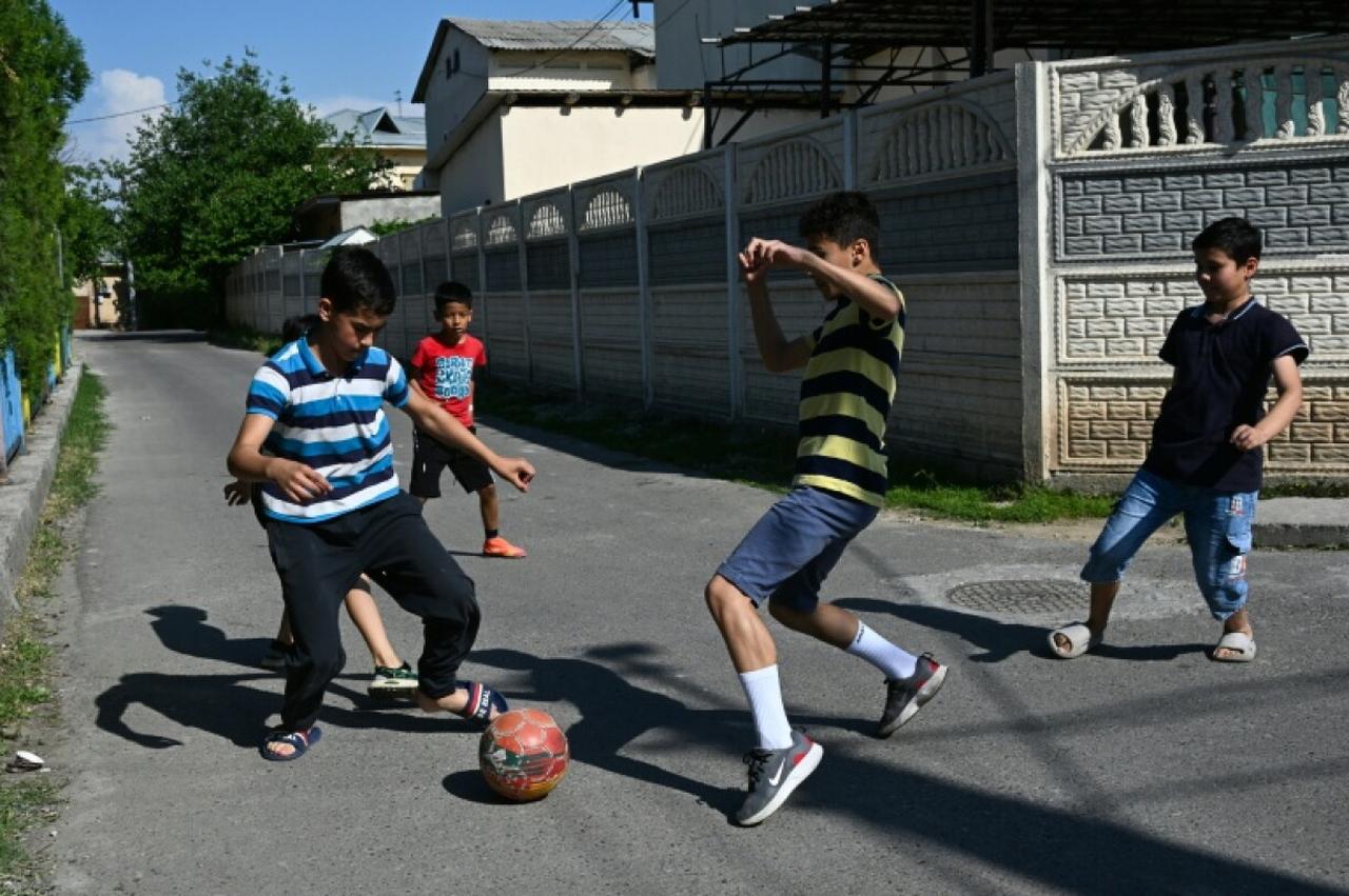 Boys play football in a street on the outskirts of Tashkent, Uzbekistan on April 28, 2026. (AFP Photo)