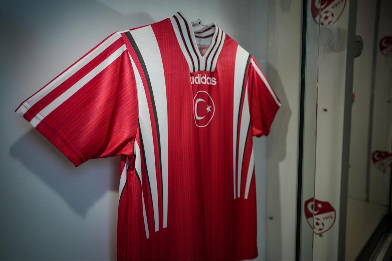 A classic white Türkiye national team jersey with the red crescent-star band is displayed as part of the national team’s jersey history exhibition. (AA Photo)
