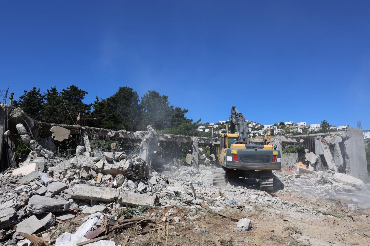 An excavator demolishes an illegal structure in Bodrum, Mugla, Türkiye, June 5, 2026. (AA Photo)