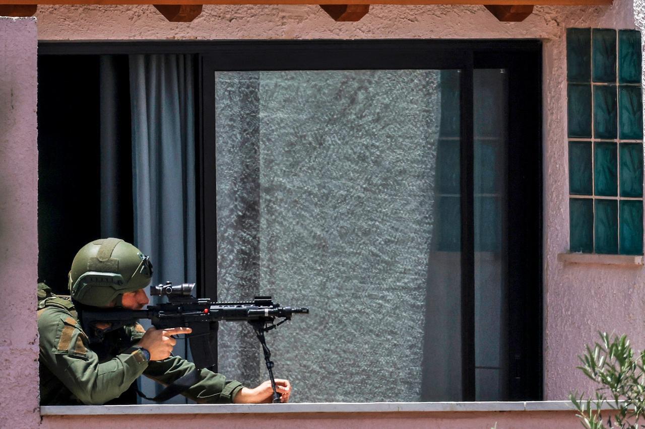 This picture, taken from a position in northern Israel on the border with southern Lebanon, shows an Israeli soldier taking position on the balcony of a building, May 31, 2026. (AFP Photo)