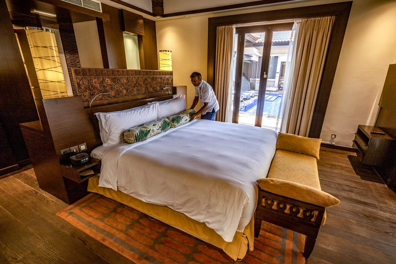 Employee arranges a bed in a room at the Anantara The Palm Dubai Resort in Dubai on June 6, 2026. (AFP Photo)