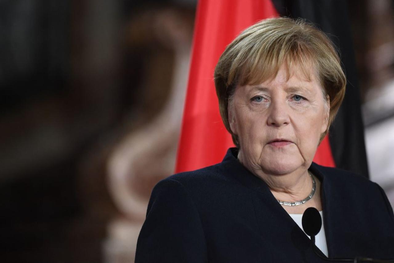Germany's Angela Merkel reacts as she delivers a speech during a press conference after her meeting with Belgium'S Alexander De Croo in Brussels, Oct. 15, 2021. (AFP Photo)