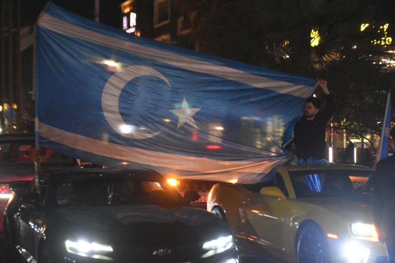 People celebrate carrying the Iraq Turkmen Front and Turkmeneli flags after Muhammed Seman Agha was elected governor of Kirkuk on April 16, 2026. (AA Photo)