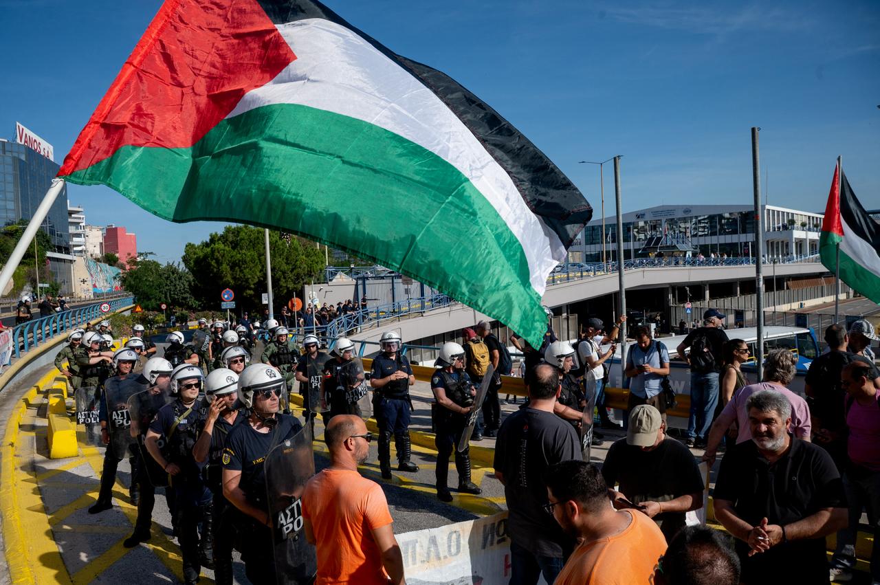 Greek security personnel stand alert in front of pro-Palestinian protestors as Israeli tourists arrive aboard Israeli owned cruise ship MS Crown Iris at the port of Piraeus in Athens on June 3, 2026, during a demonstration against Israeli tourists visiting Greece. (AFP Photo)