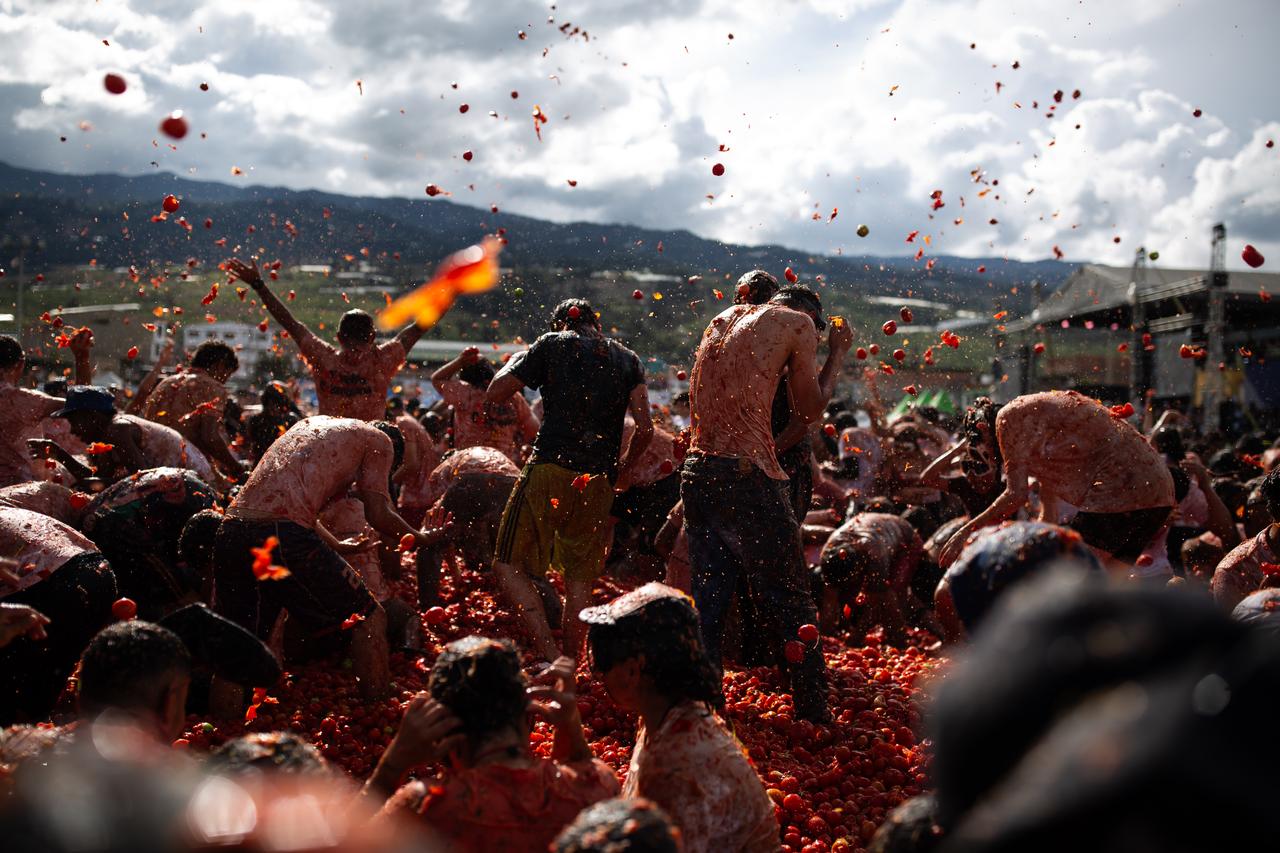 Locals and tourists participate in a massive tomato fight during the 16th edition of the Great Colombian Tomatina in Sutamarchan, Colombia, on June 07, 2026. (AA Photo)
