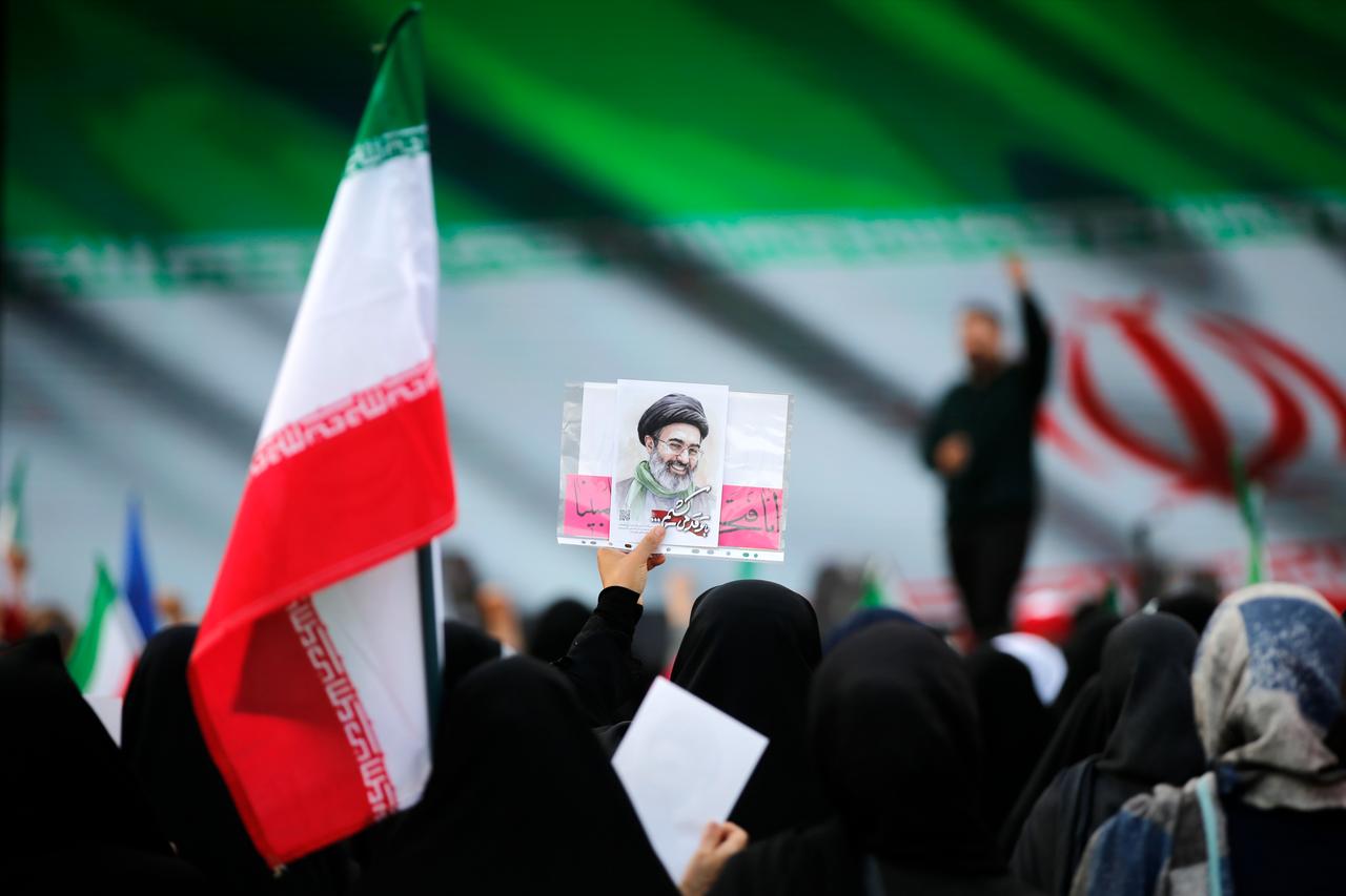 Iranians carry flags as they participate in a march pledging loyalty to new leader Mojtaba Khamenei in Tehran, Iran, April 29, 2026. (AA Photo)