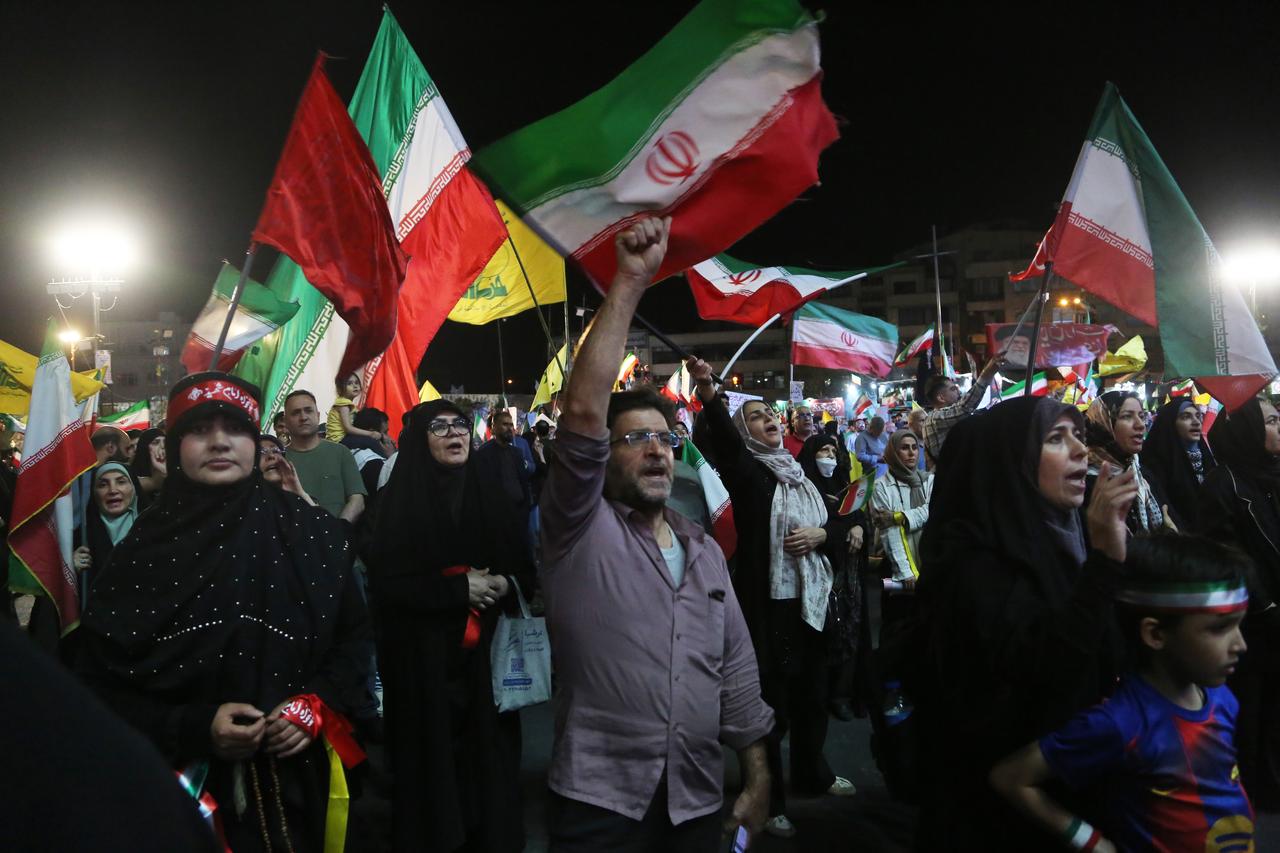 Citizens, carrying Iranian and Hezbollah flags, gather at Enghelab Square to hold a demonstration in support of the government following Iran's missile attack on Israel, in the capital Tehran, Iran, June 08, 2026. (AA Photo)