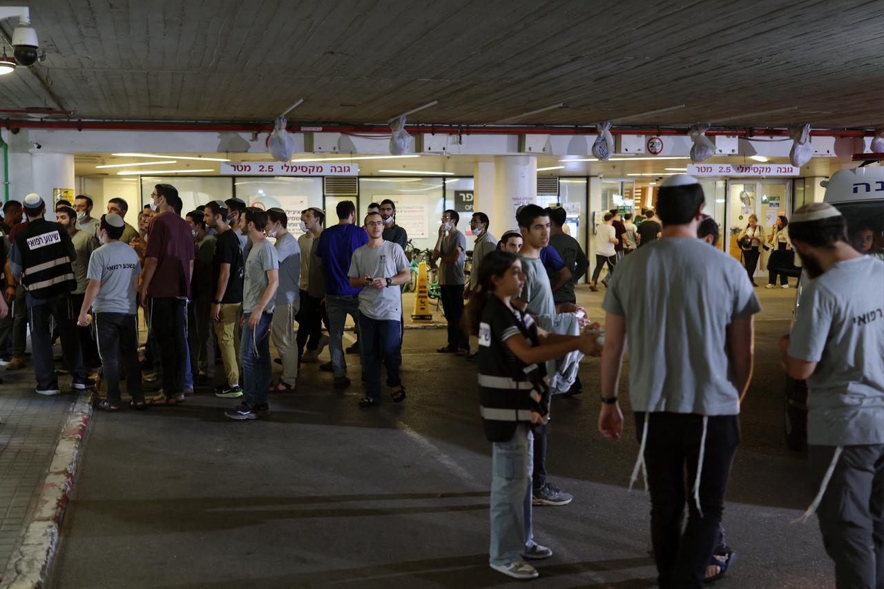 People gather at a holding area before transferring patients to an underground facility of a hospital in Tel Aviv, June 8, 2026. (AFP Photo)