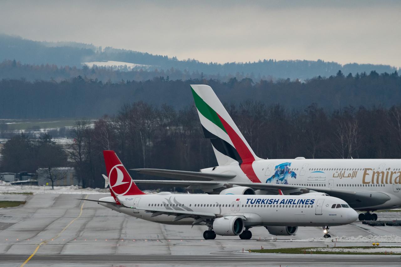 A Turkish Airlines Airbus A321neo taxis with an Emirates aircraft parked in the background at Zurich Airport in Zurich, Switzerland, Dec. 6, 2023. (Adobe Stock Photo)
