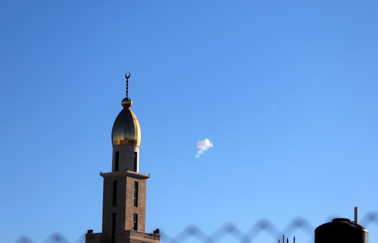 A cloud of smoke is seen in the sky near a mosque minaret in Palestine's West Bank city of Hebron following an attempted interception of Iranian missiles on June 8, 2026. (AA Photo)