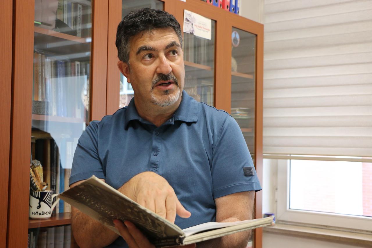 Professor Ali Umut Turkcan, head of the Kanlitas Hoyuk excavation team, examines research material at Anadolu University in Eskisehir, Türkiye. (AA Photo)
