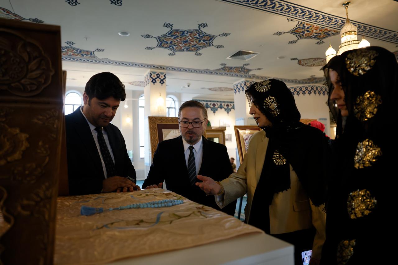 Guests view a displayed artwork during the “Kubbe-i Mina” exhibition, which presents Ottoman mosques through illumination and miniature art in Moscow, Russia. (AA Photo)