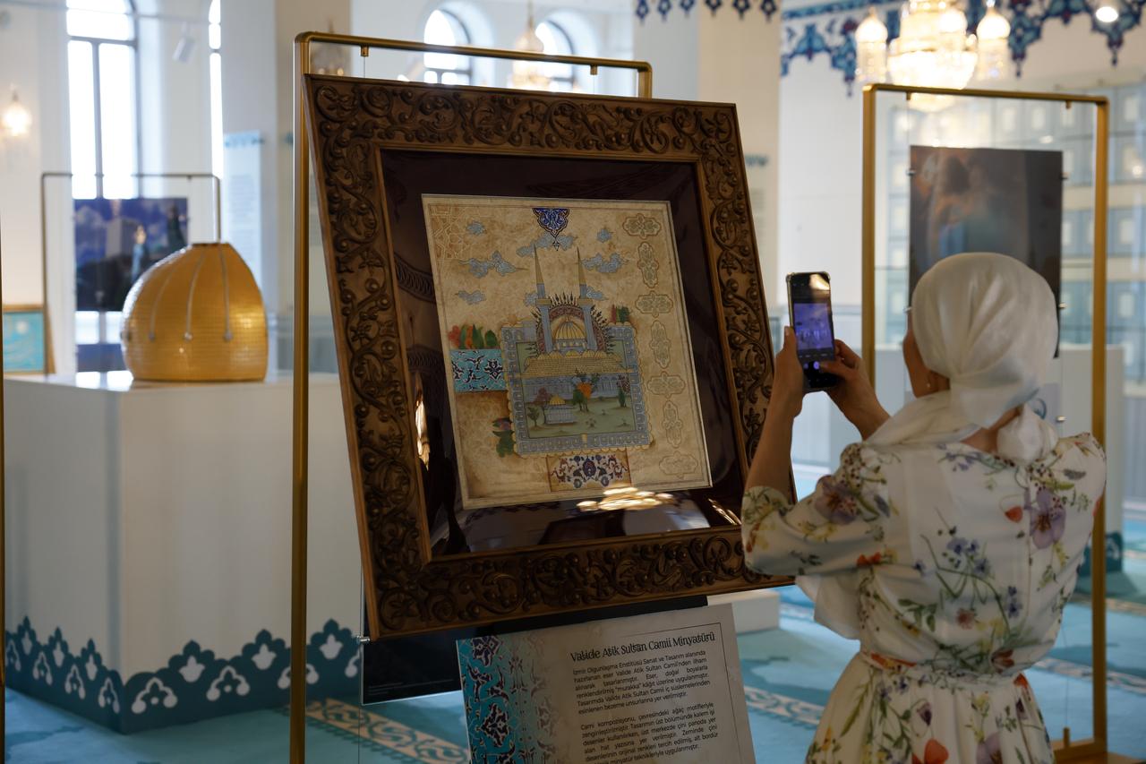 A visitor takes a photo of a miniature artwork at the Ottoman mosque art exhibition held at Moscow Central Mosque in Russia. (AA Photo)