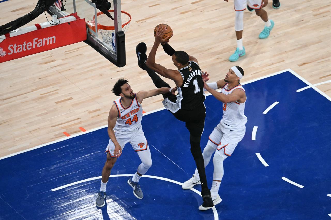 San Antonio Spurs' forward-center #01 Victor Wembanyama shoots the ball while being defended by Knicks guard #44 Landry Shamet and Knick guard #03 Josh Hart in New York, United State, on June 8, 2026. (AFP Photo)