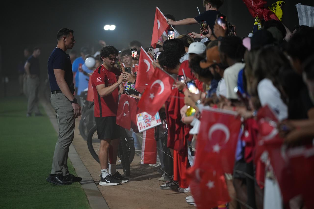 Turkish National Football Team player Ferdi Kadioglu signs autographs for fans after participating with his teammates, under the guidance of head coach Vincenzo Montella, in an open training session ahead of the 2026 FIFA World Cup at Arizona Athletic Grounds in Mesa, Arizona, June 8, 2026. (AA Photo)