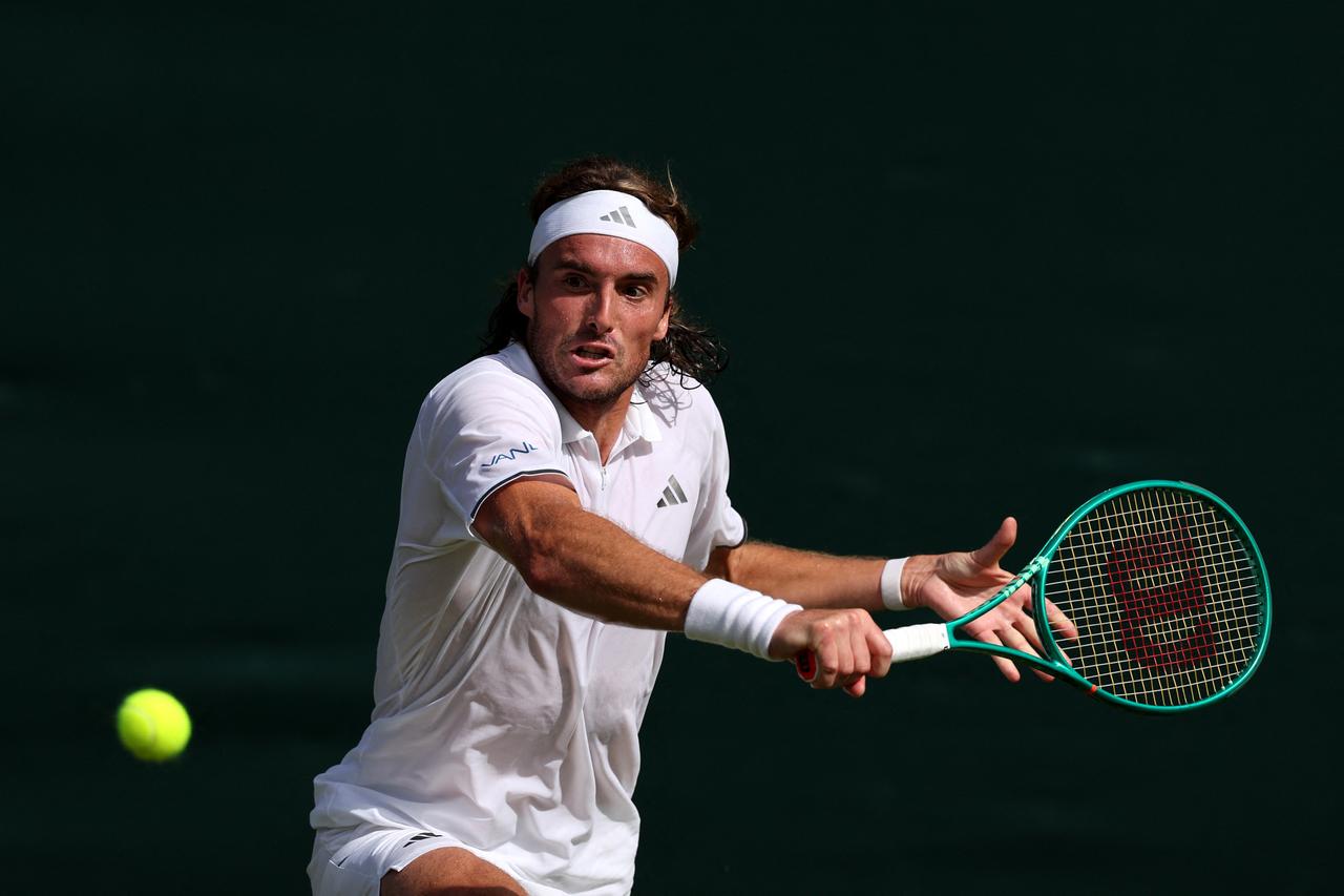 Greece's Stefanos Tsitsipas returns to France's Hugo Gaston during their men's singles first round tennis match on the first day of the 2026 Wimbledon Championships at The All England Lawn Tennis and Croquet Club in Wimbledon, southwest London, on June 29, 2026. (AFP Photo)