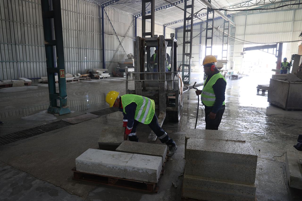 Workers handle processed kufeki stone blocks at a facility in Edirne before their use in restoration works. (AA Photo)