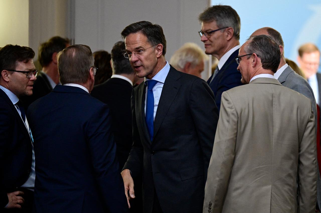 NATO Secretary General Mark Rutte (C) speaks to German Defence Minister Boris Pistorius after posing for a group photo prior to a weekly meeting of the German cabinet at the Defence Ministry in Berlin, Germany, July 1, 2026. (AFP Photo)
