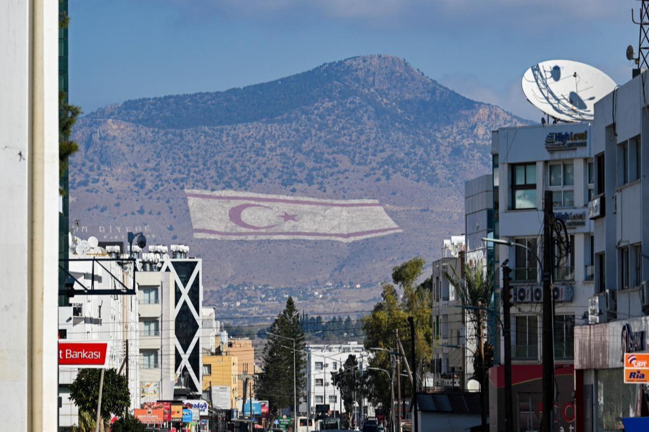 A view of a TRNC flag on the Besparmak Mountains ahead of the first round of the presidential election, where eight candidates will compete on Sunday in Lefkosia, Turkish Republic of Northern Cyprus, October 17, 2025. (AA Photo)