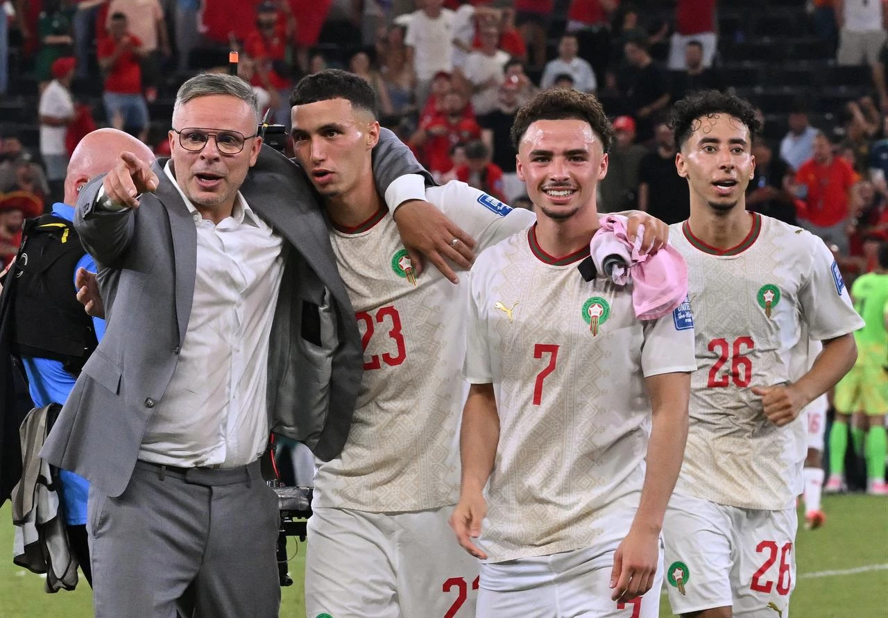 Morocco's head coach Mohamed Ouahbi celebrates with his players midfielder #23 Bilal El Khannouss, forward #07 Chemsdine Talbi and defender #26 Anass Salah-Eddine after winning the penalty shootout of the 2026 World Cup round of 32 football match between the Netherlands and Morocco at the Monterrey Stadium in Guadalupe on June 29, 2026. (AFP Photo)
