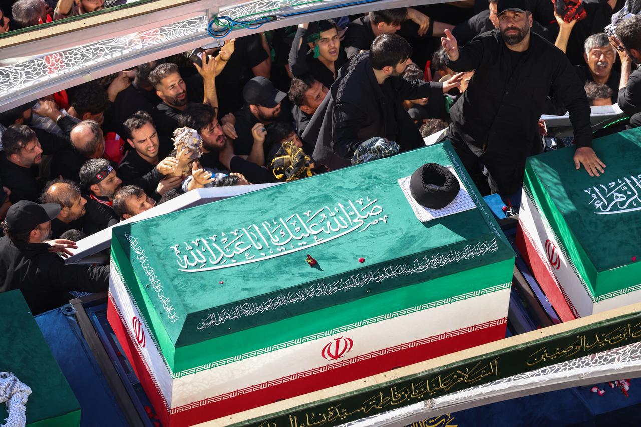 Crowds of mourners surround the convoy carrying the coffins of Iran's slain supreme leader Ali Khamenei and members of his family during a funeral procession, before he is buried at the Shrine of Imam Reza, in Mashhad, July 9, 2026.