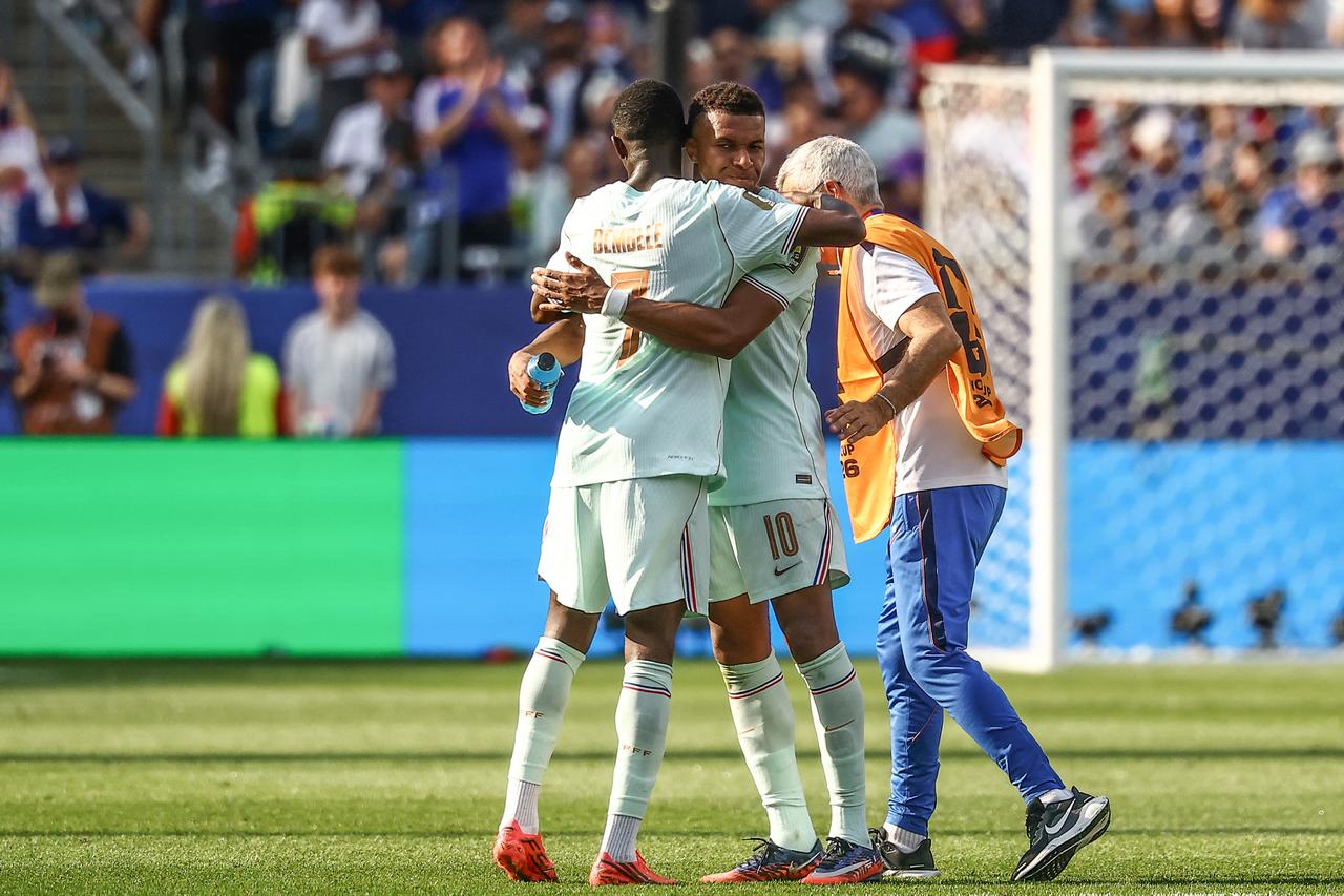 France's forward #10 Kylian Mbappe hugs France's forward #07 Ousmane Dembele before leaves the pitch after being substituted during the 2026 World Cup football tournament quarter-final match between France and Morocco at Boston Stadium in Foxborough on July 9, 2026. (AFP Photo)